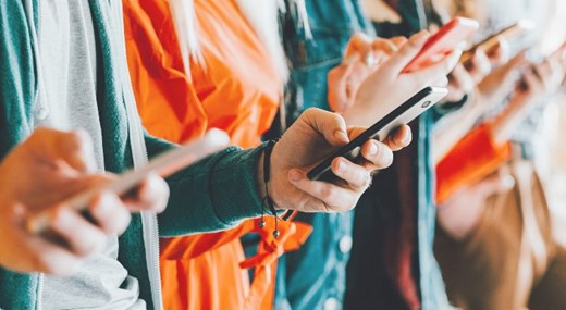 Image of people's hands holding phones